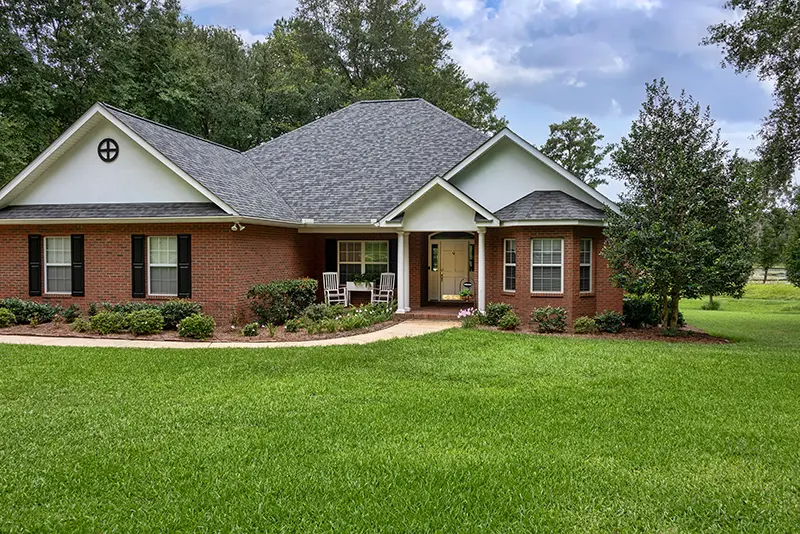 Traditional brick house in Tallahassee FL on green lawn